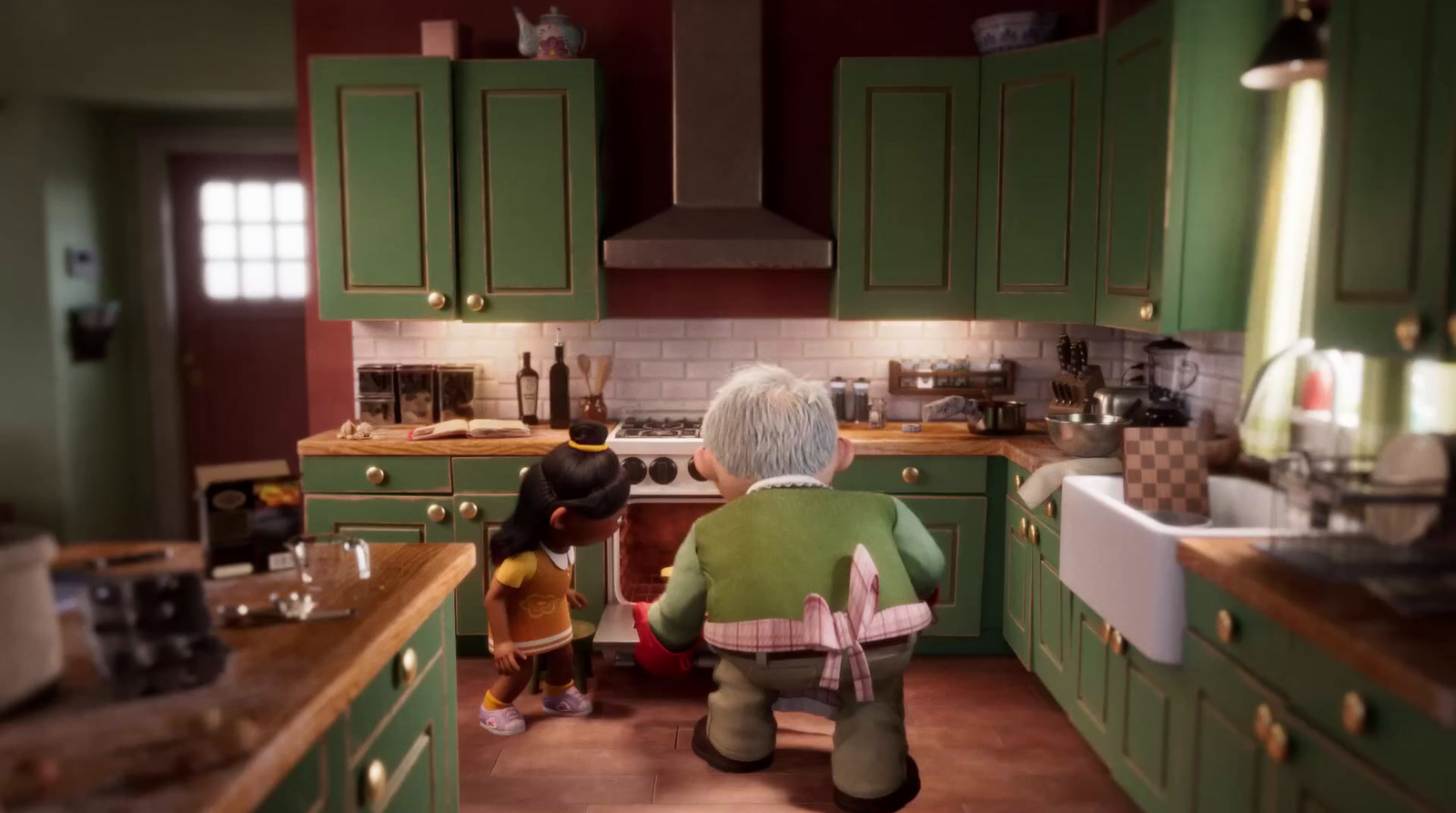 a woman and a child in a green kitchen