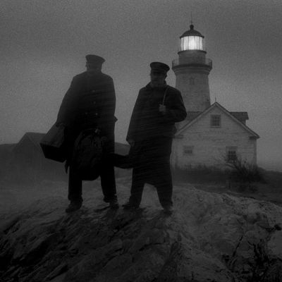 a couple of men standing on top of a rocky hill