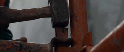 a close up of a person holding a piece of metal