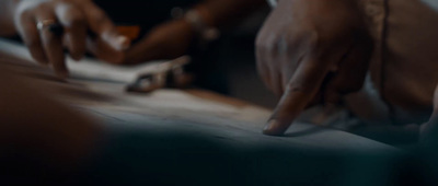 a close up of a person writing on a piece of paper