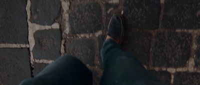 a person standing next to a brick wall