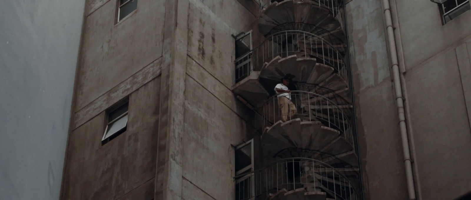 a tall building with a spiral staircase next to it