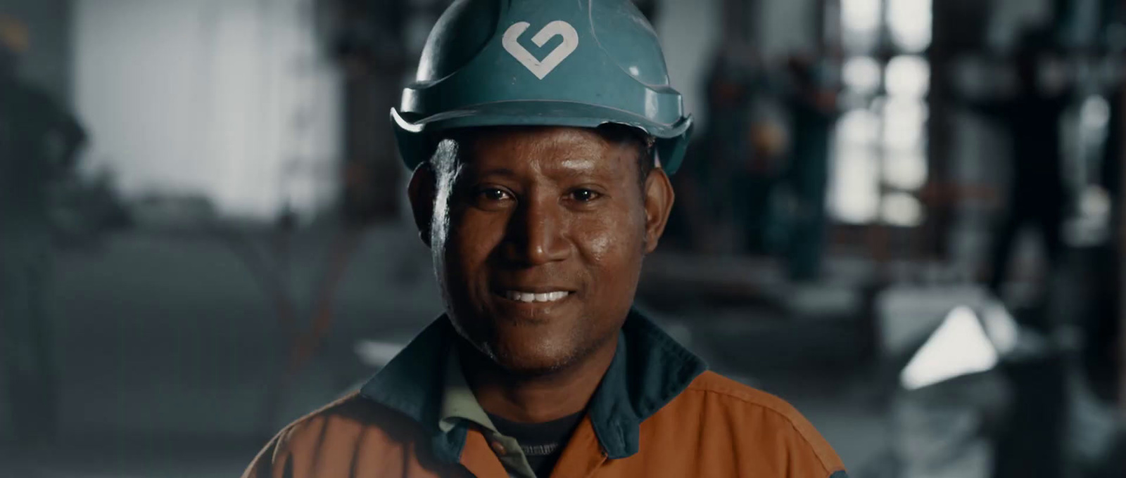 a man wearing a hard hat in a factory