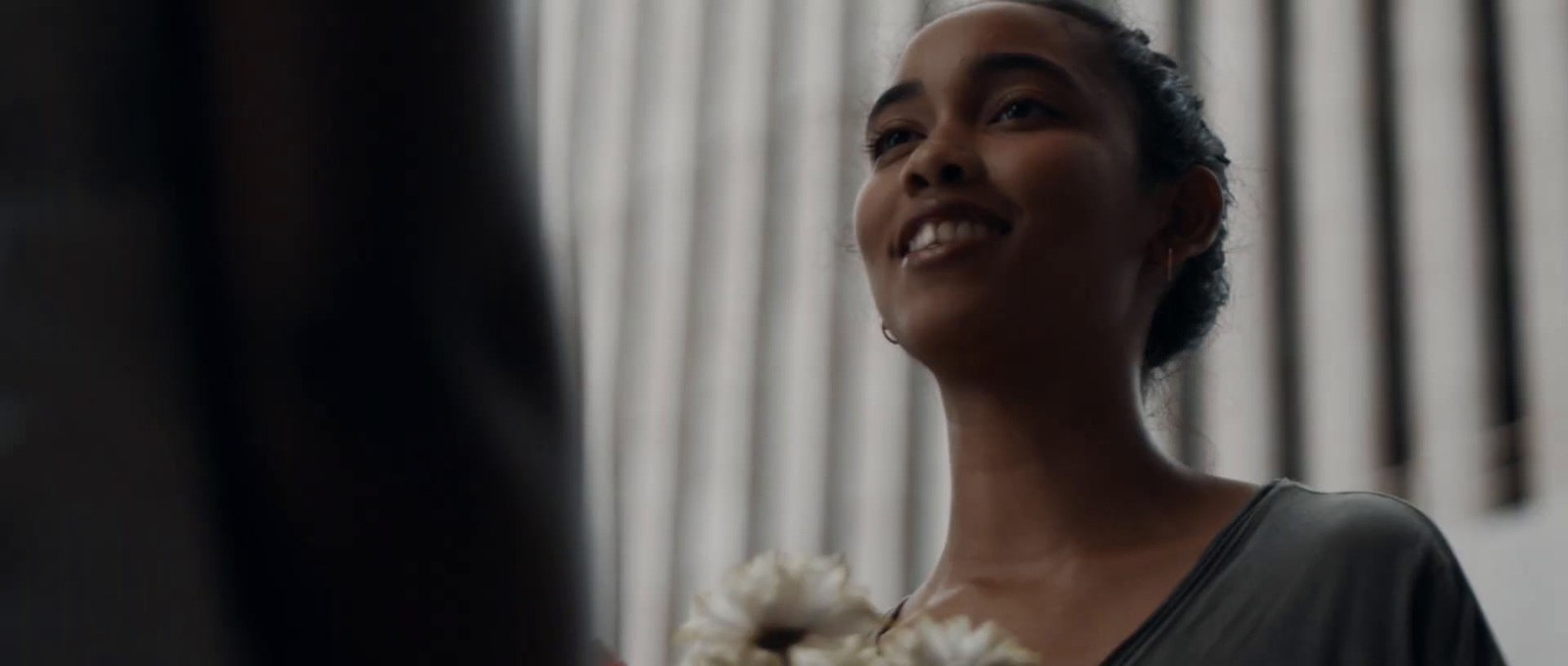 a woman holding a bouquet of flowers in her hand