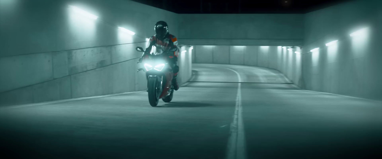 a person riding a motorcycle in a tunnel