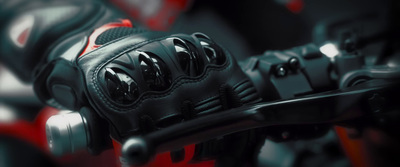 a close up of a black and red motorcycle glove