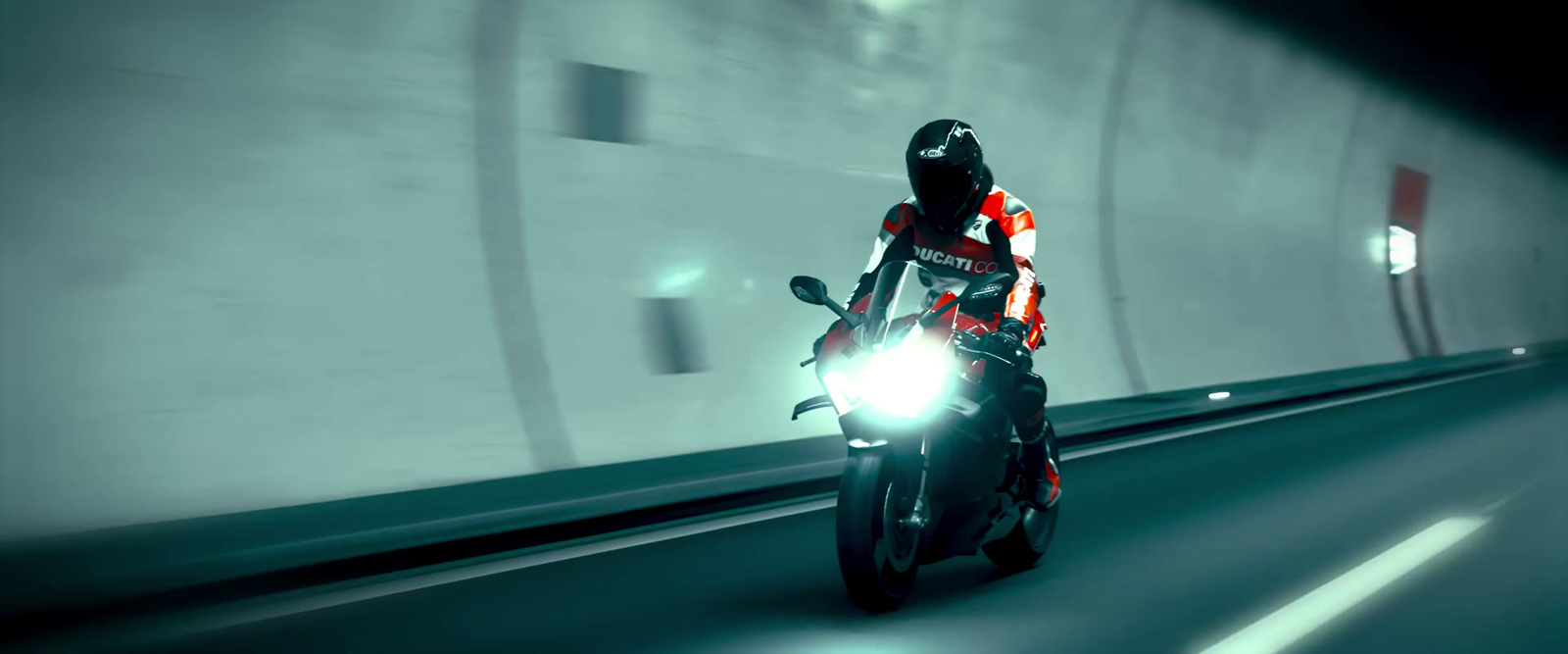 a person riding a motorcycle in a tunnel