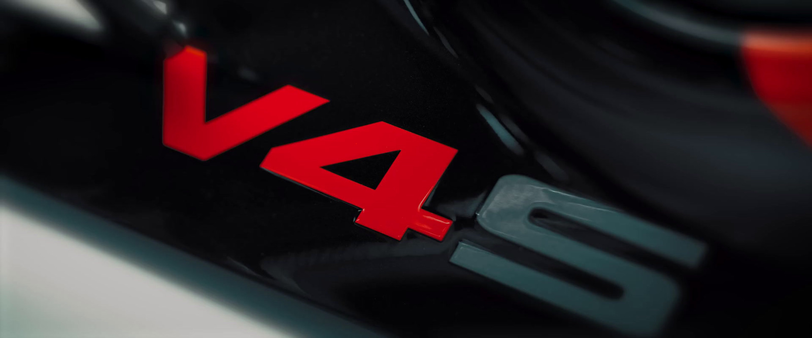 a close up of a red and black logo on a motorcycle