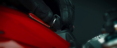 a close up of a red suitcase with a black background