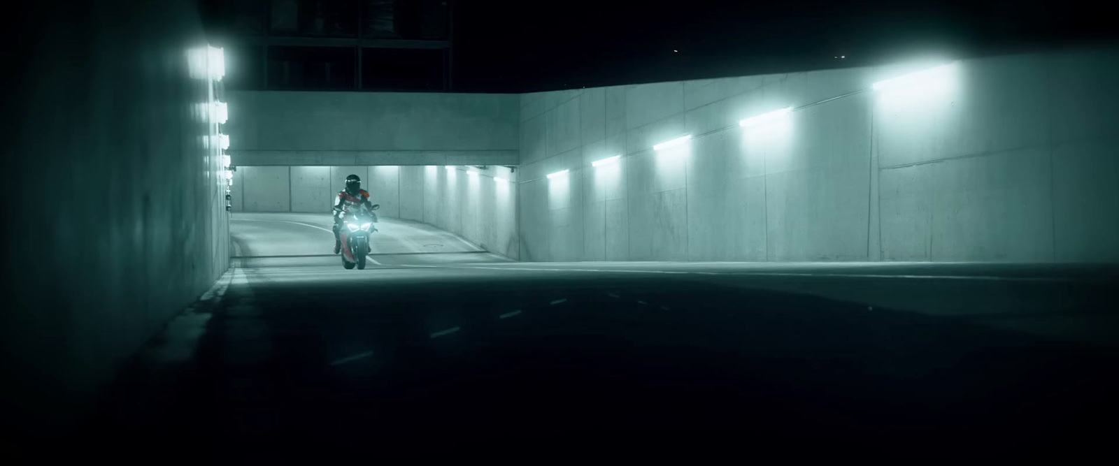 a person riding a bike through a tunnel