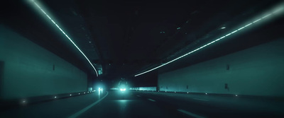 a car driving through a tunnel at night