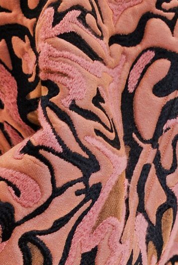 a close up of a pink and black fabric