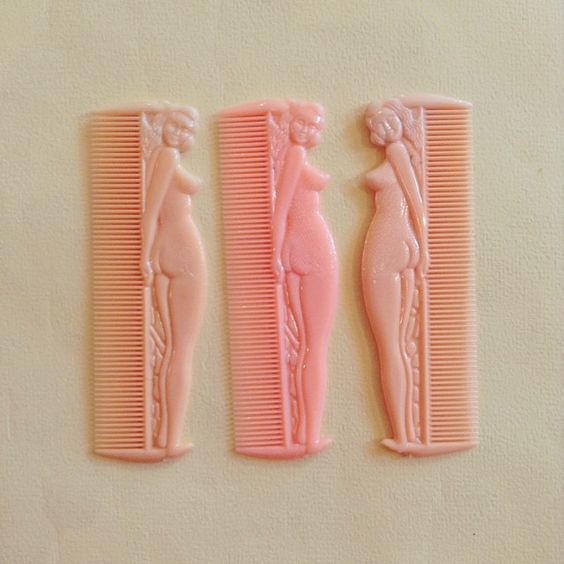 a couple of pink combs sitting on top of a table