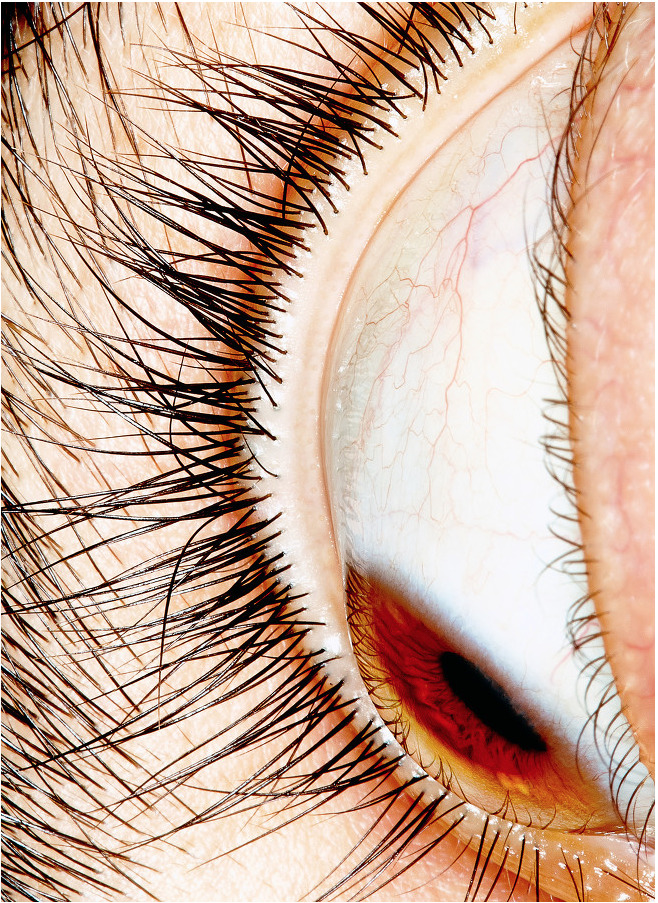 a close up of a person's eye with long eyelashes