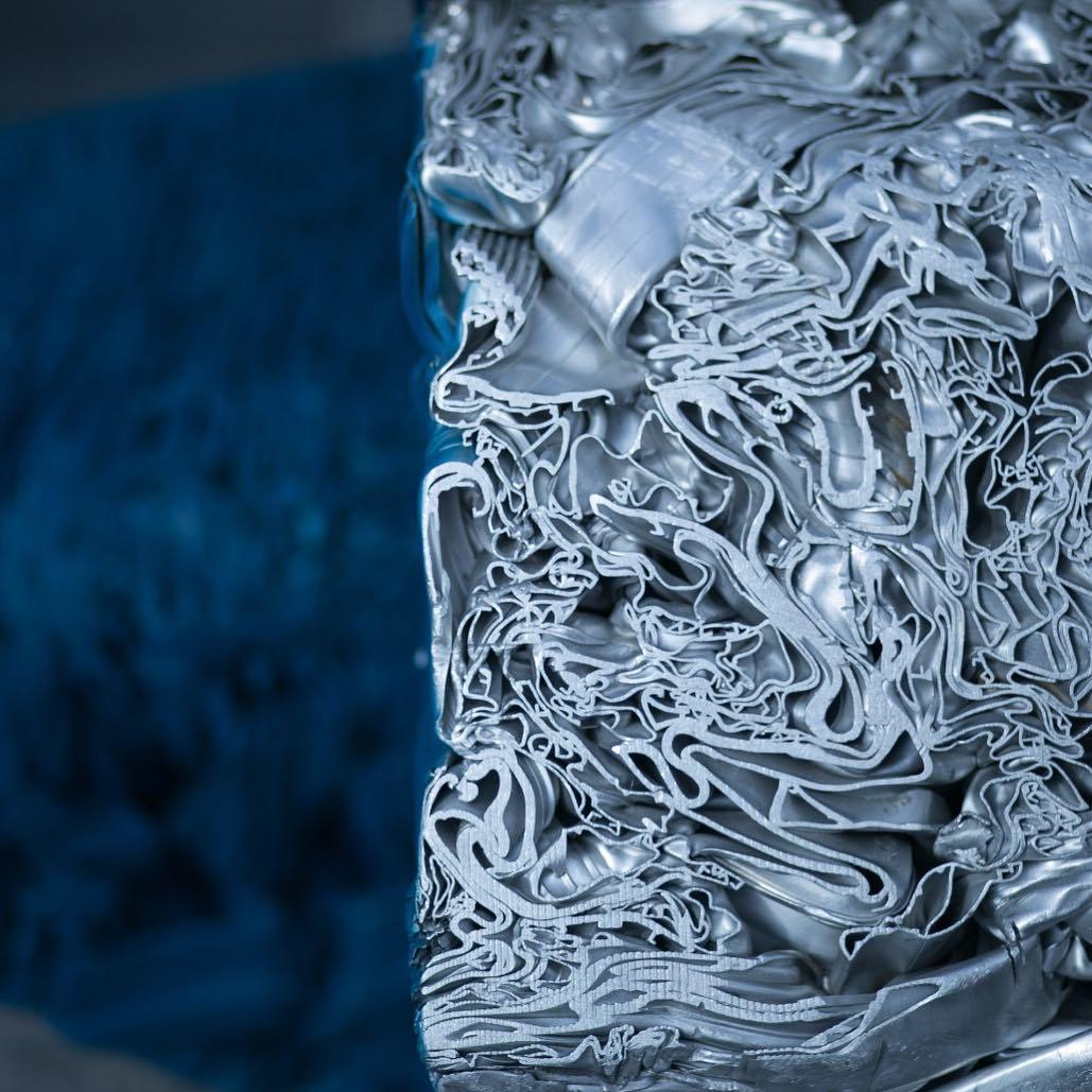 a close up of a metal object with a blue background