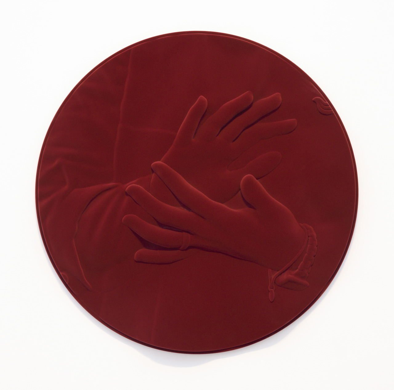 a red circular object with a hand on it