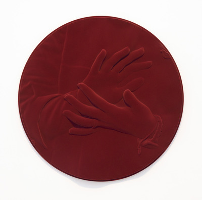 a red circular object with a hand on it