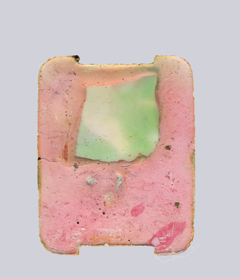 a piece of pink and green soap with a square shape