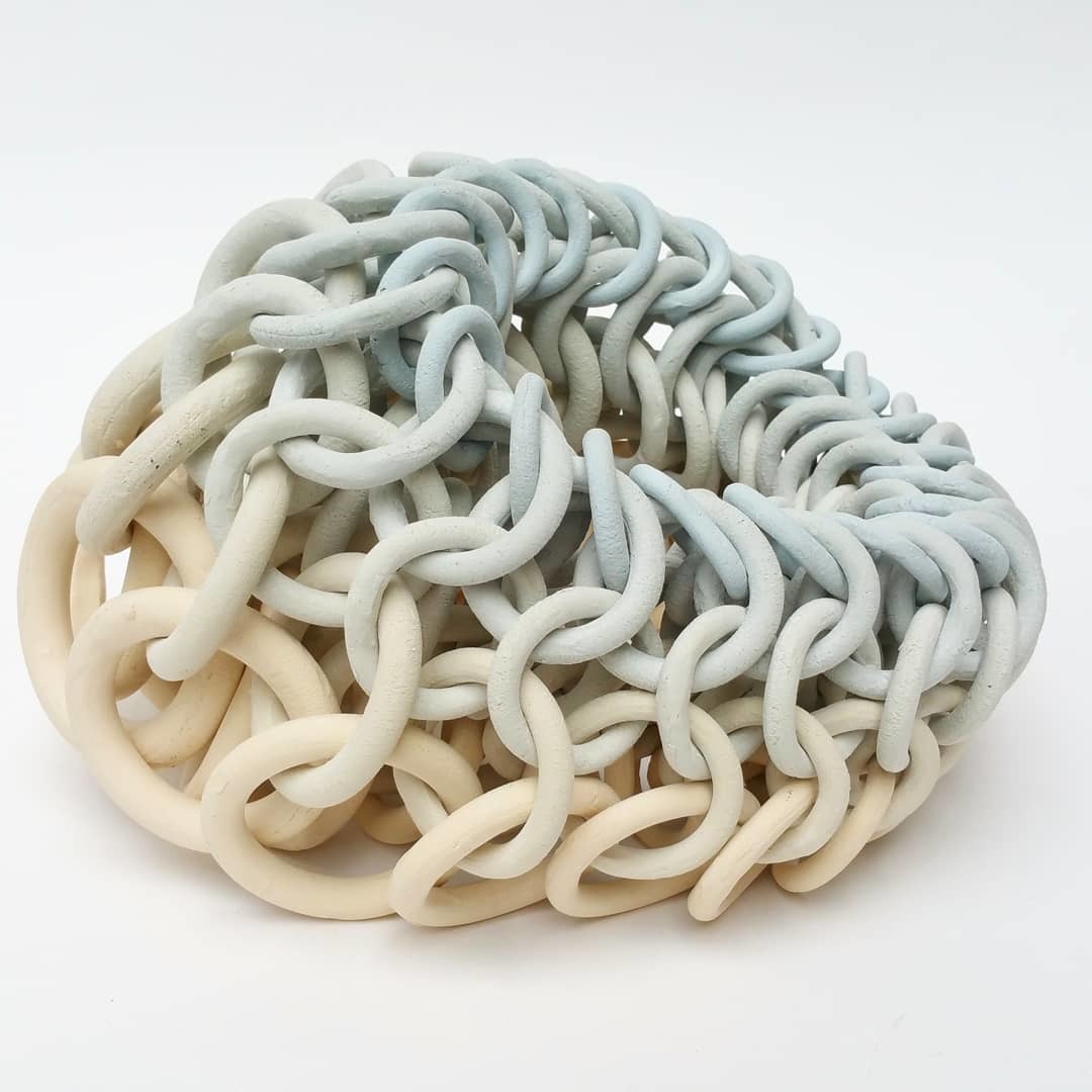 a bunch of white and blue chains on a white surface