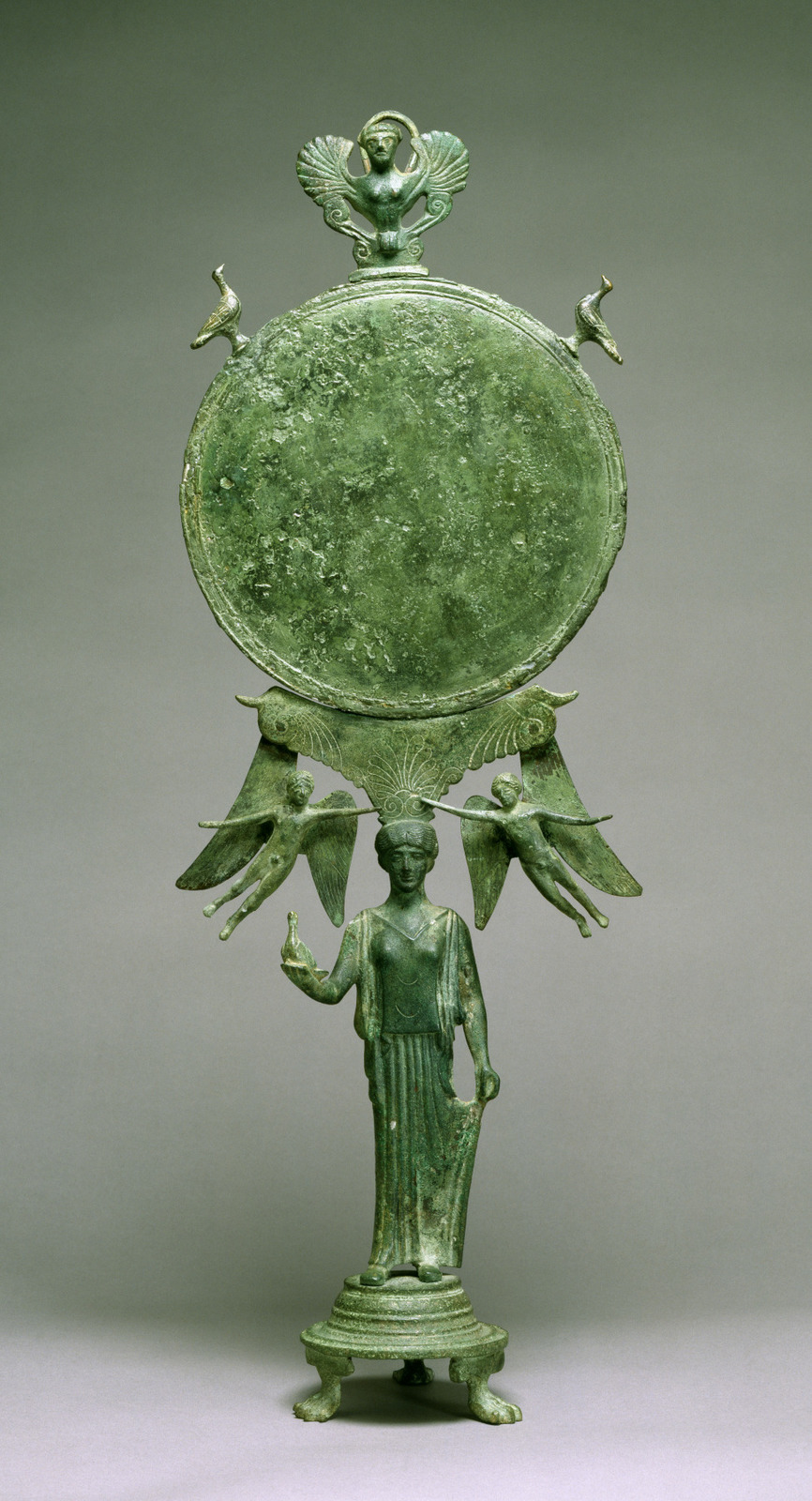 a green vase with a statue of a man holding a bird