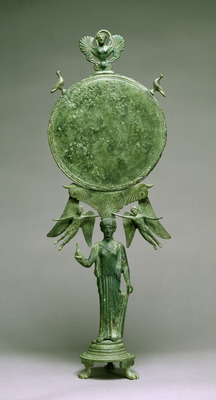 a green vase with a statue of a man holding a bird