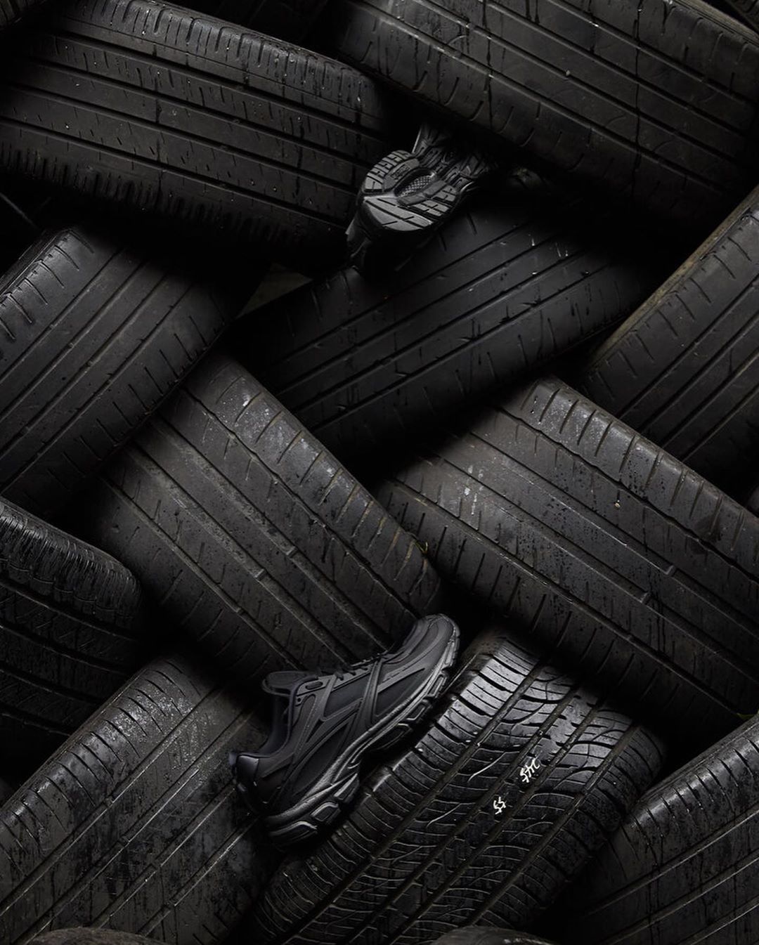 a pile of black tires stacked on top of each other