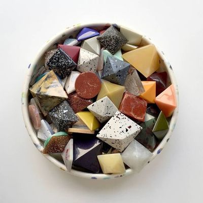 a bowl filled with lots of different colored rocks