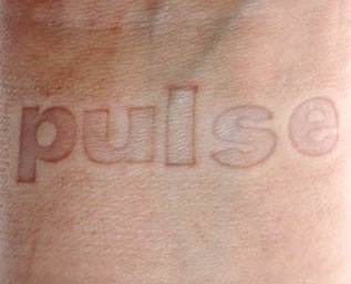 a close up of a person's wrist with the word pulse written on it