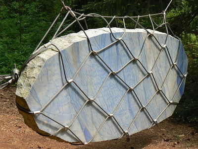 a rock with a chain link fence around it