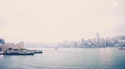 a body of water with a city in the background