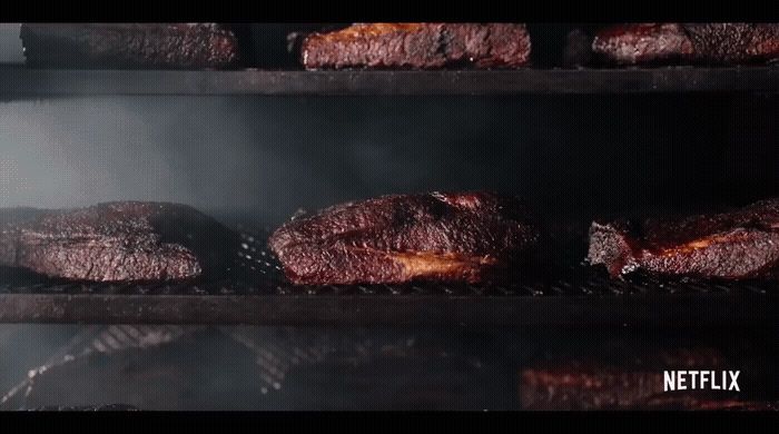 a close up of food cooking on a grill