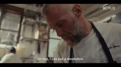 a man in a white shirt and tie in a kitchen