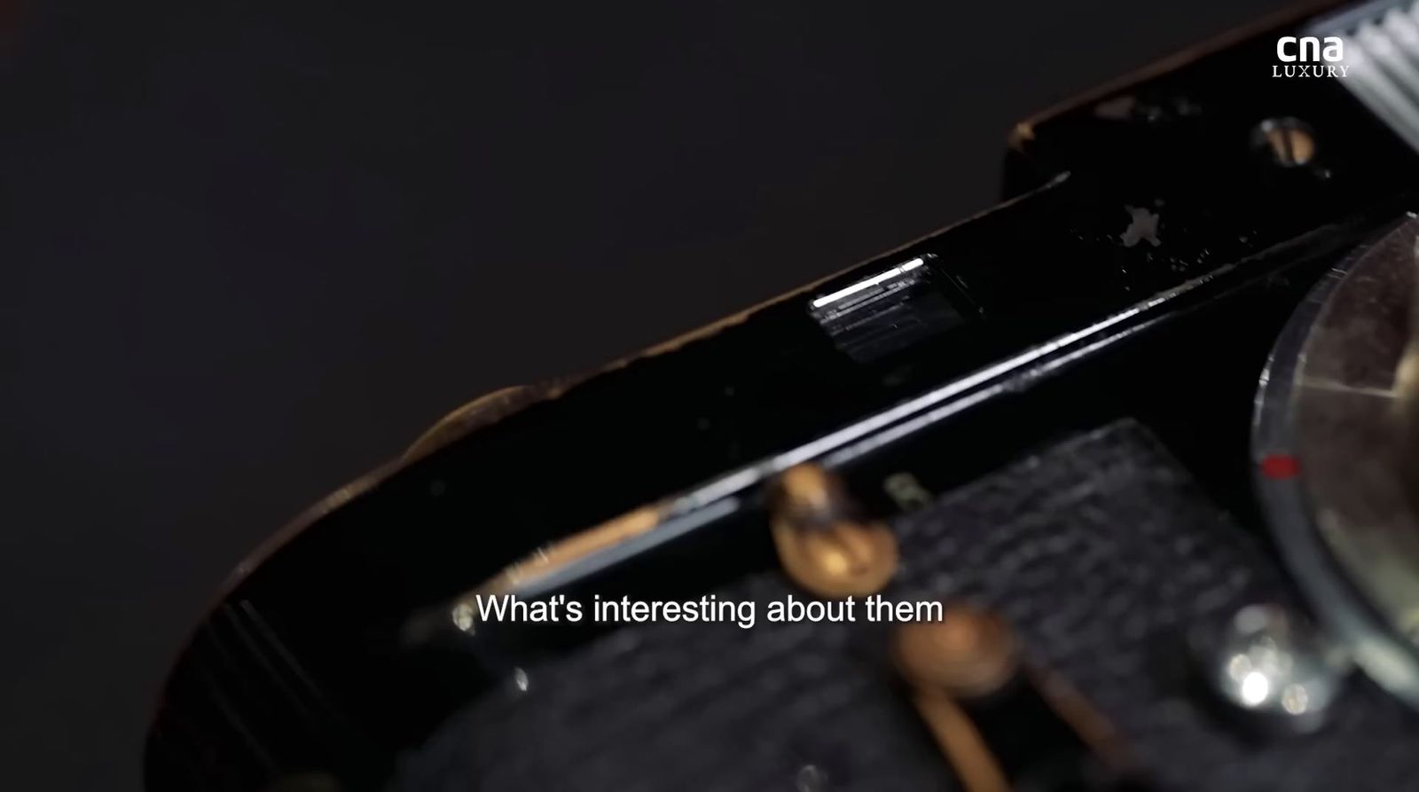 a close up of a watch on a black surface