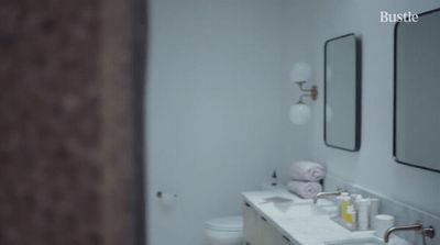 a bathroom with two sinks and a mirror