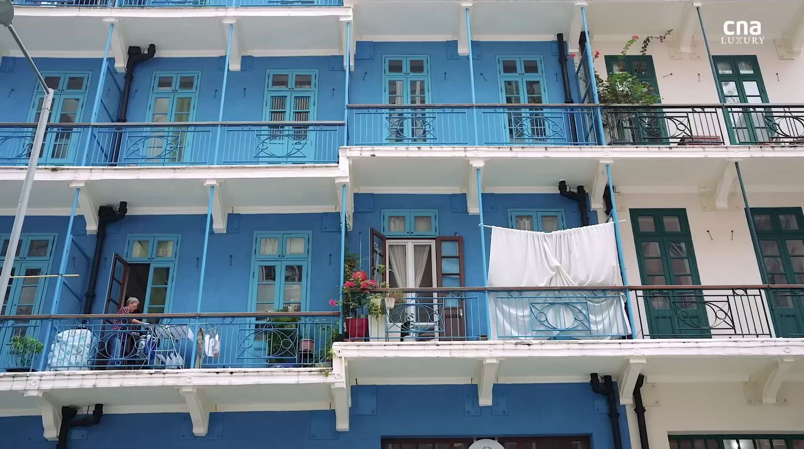 a blue and white building with balconies and balconies