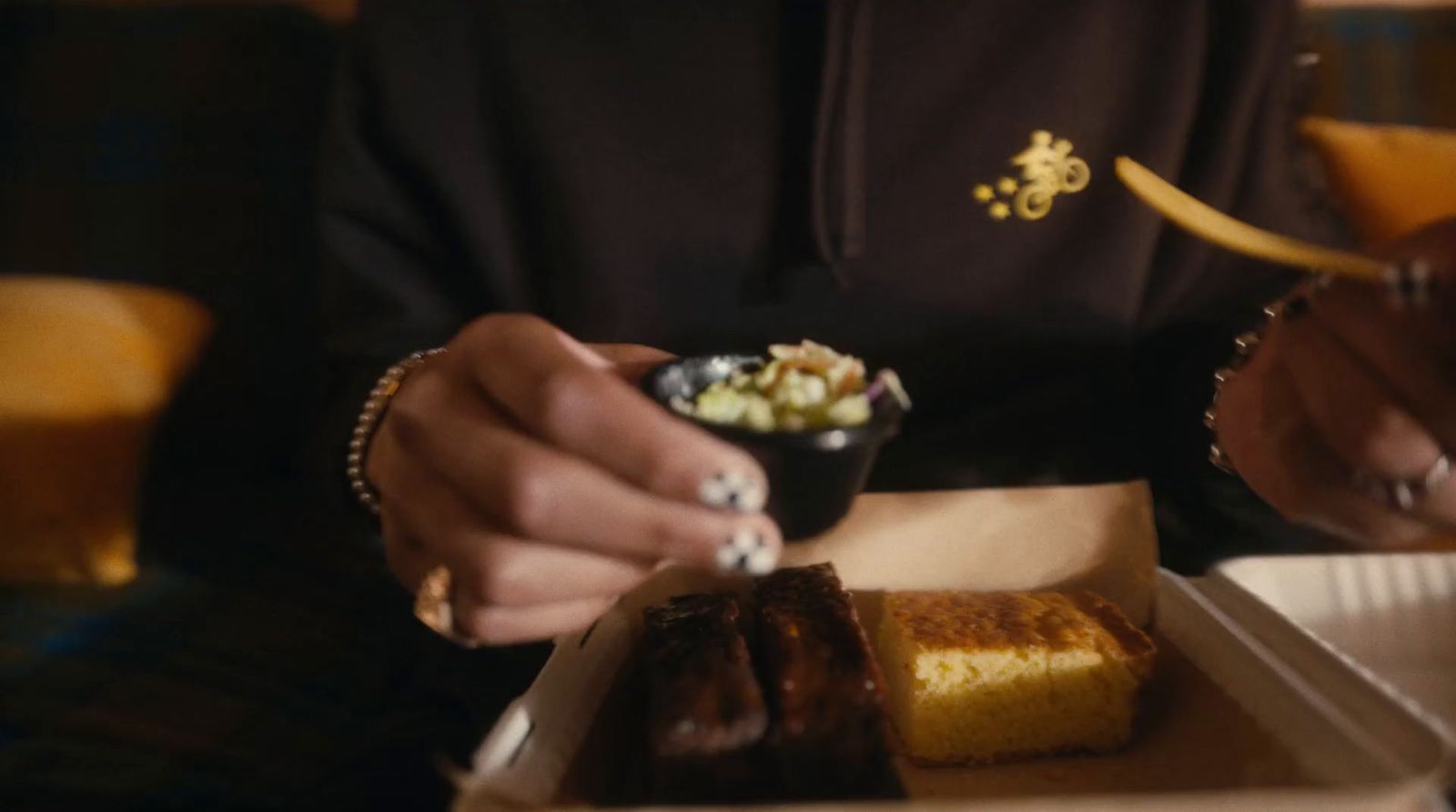 a person sitting at a table eating food