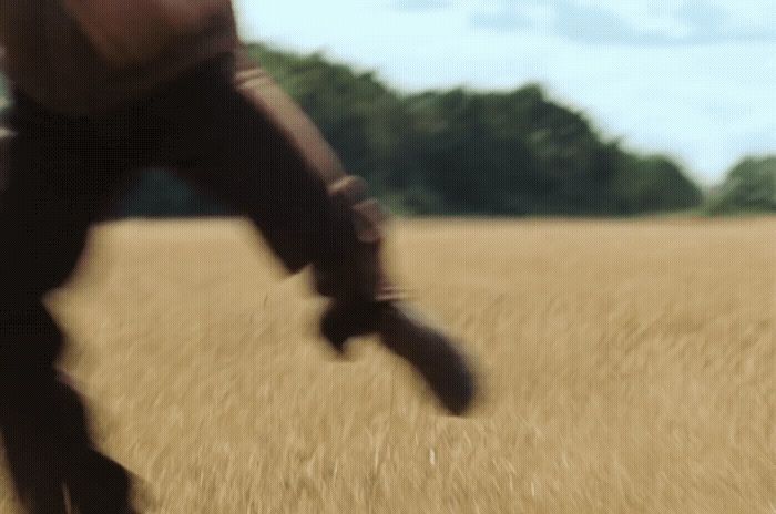 a blurry photo of a person walking through a field