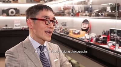 a man wearing glasses and a suit in a store