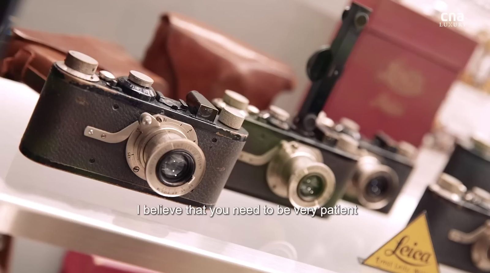 a couple of old cameras sitting on top of a table