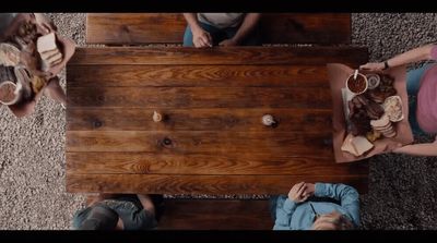 a group of people sitting around a wooden table