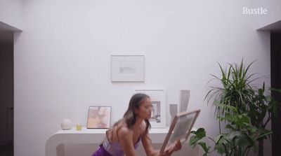 a woman sitting on a toilet reading a magazine