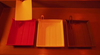 three different colored trays sitting on a table