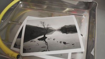 a bunch of polaroid pictures sitting on top of a metal tray