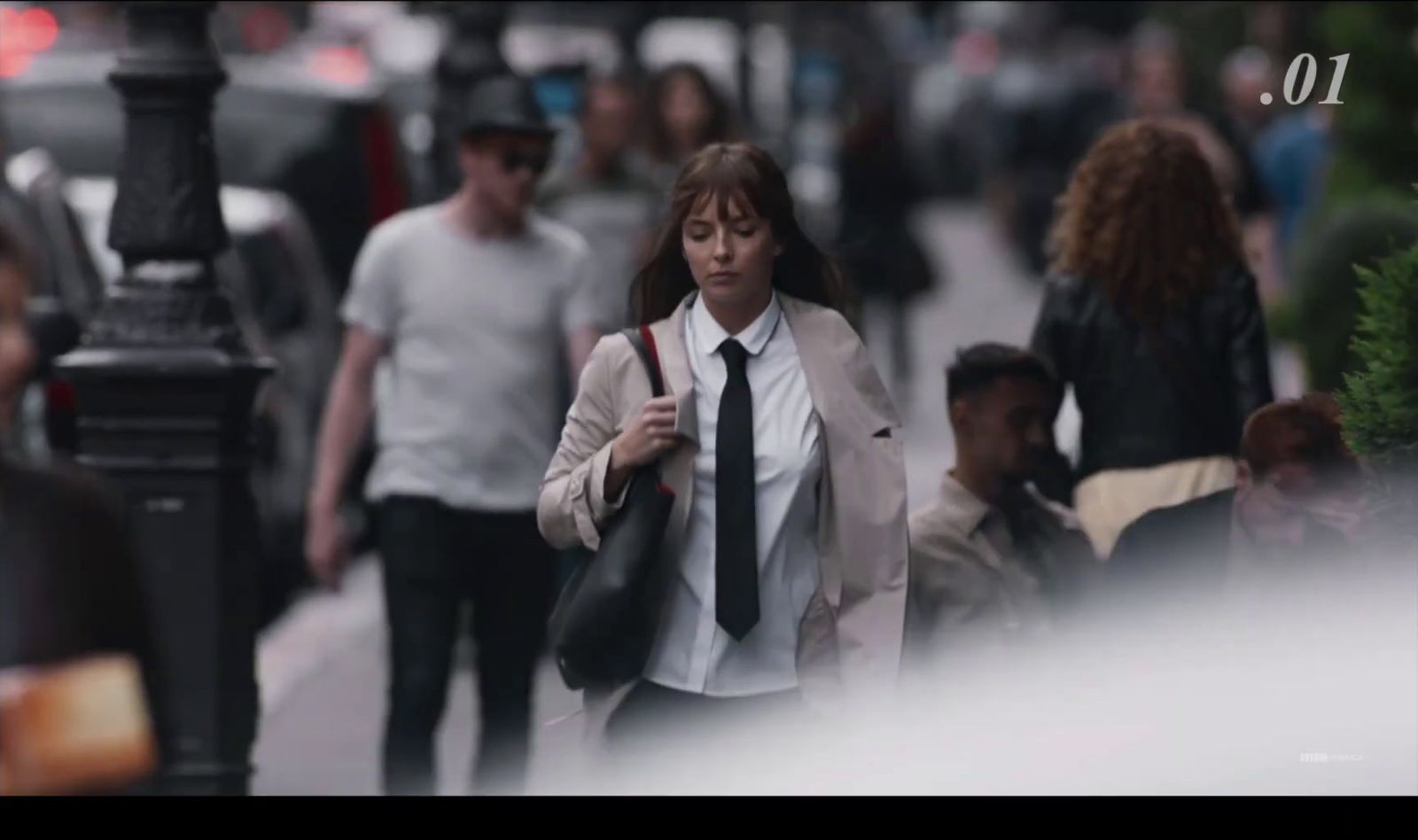 a woman walking down a busy city street