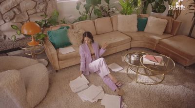 a woman sitting on the floor of a living room