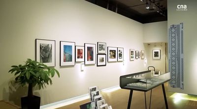 a room with a table and pictures on the wall