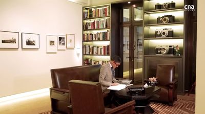 a man sitting at a desk in a library