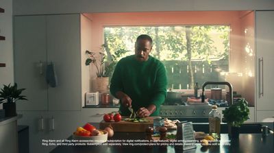 a man standing in a kitchen preparing food