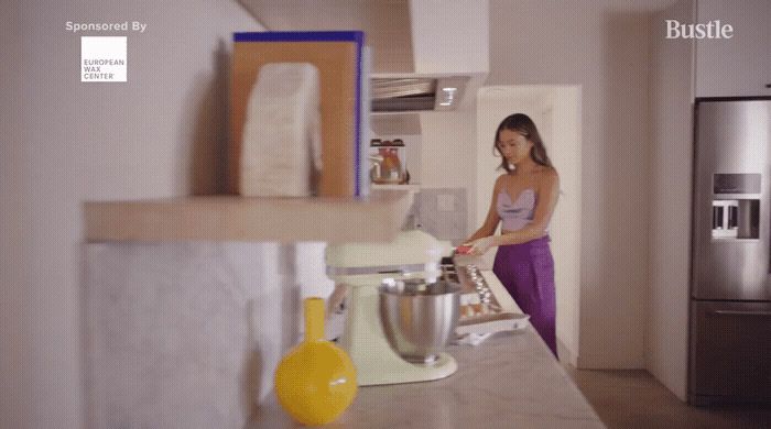 a woman standing in a kitchen next to a counter