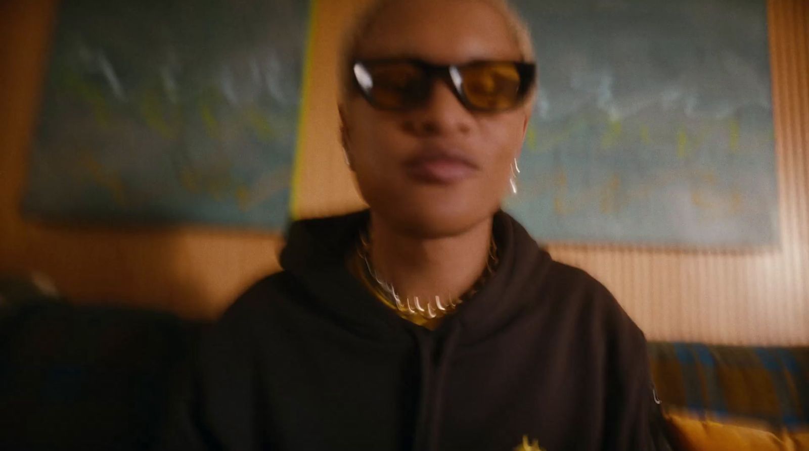 a woman wearing sunglasses and a black hoodie